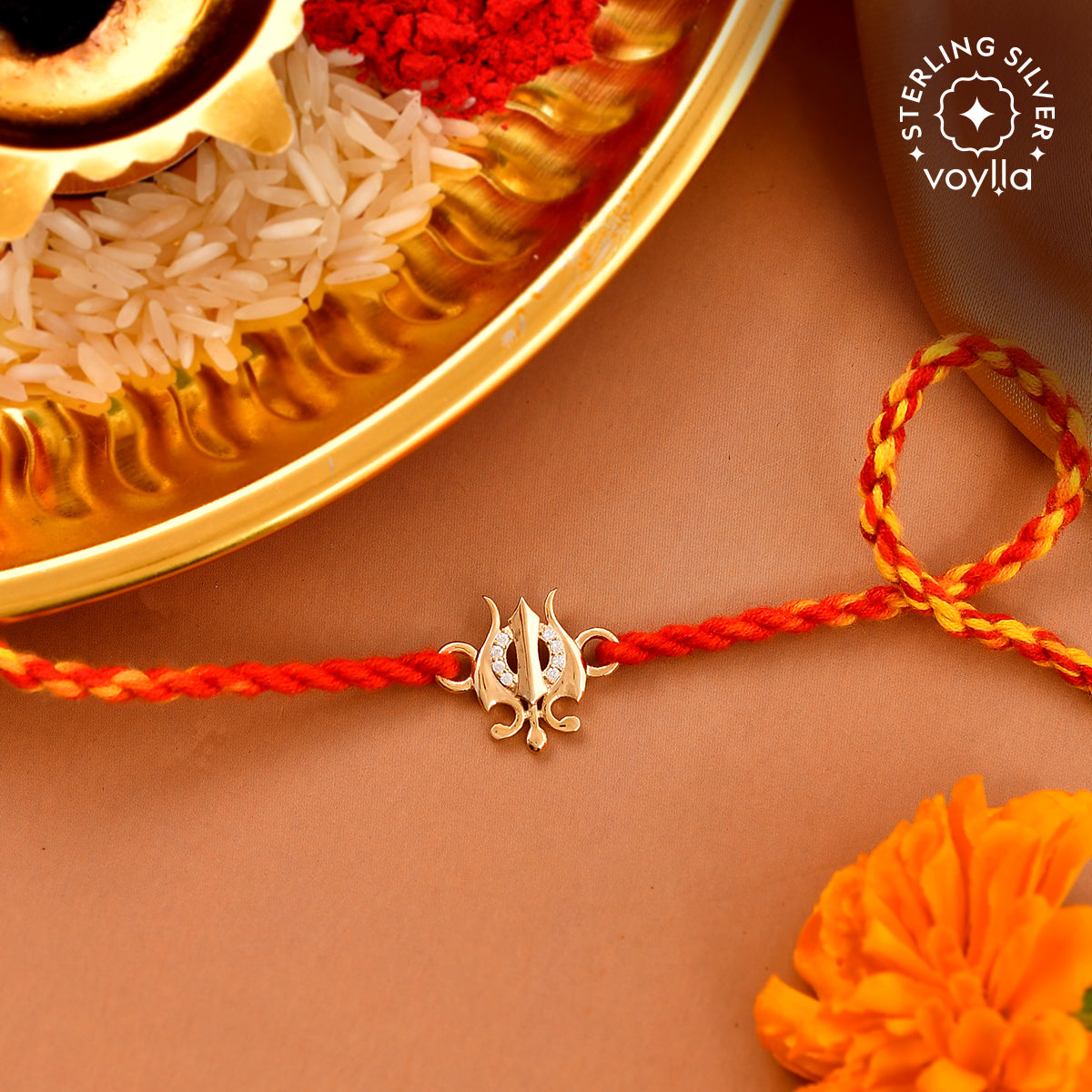 Silver Trishul rakhi featuring a finely crafted trident symbol on a durable red thread, representing strength and protection.