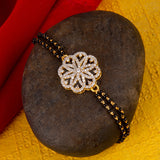 Shimmering Floret American Diamond CZ Golden Round Brass Black Beaded Bracelet